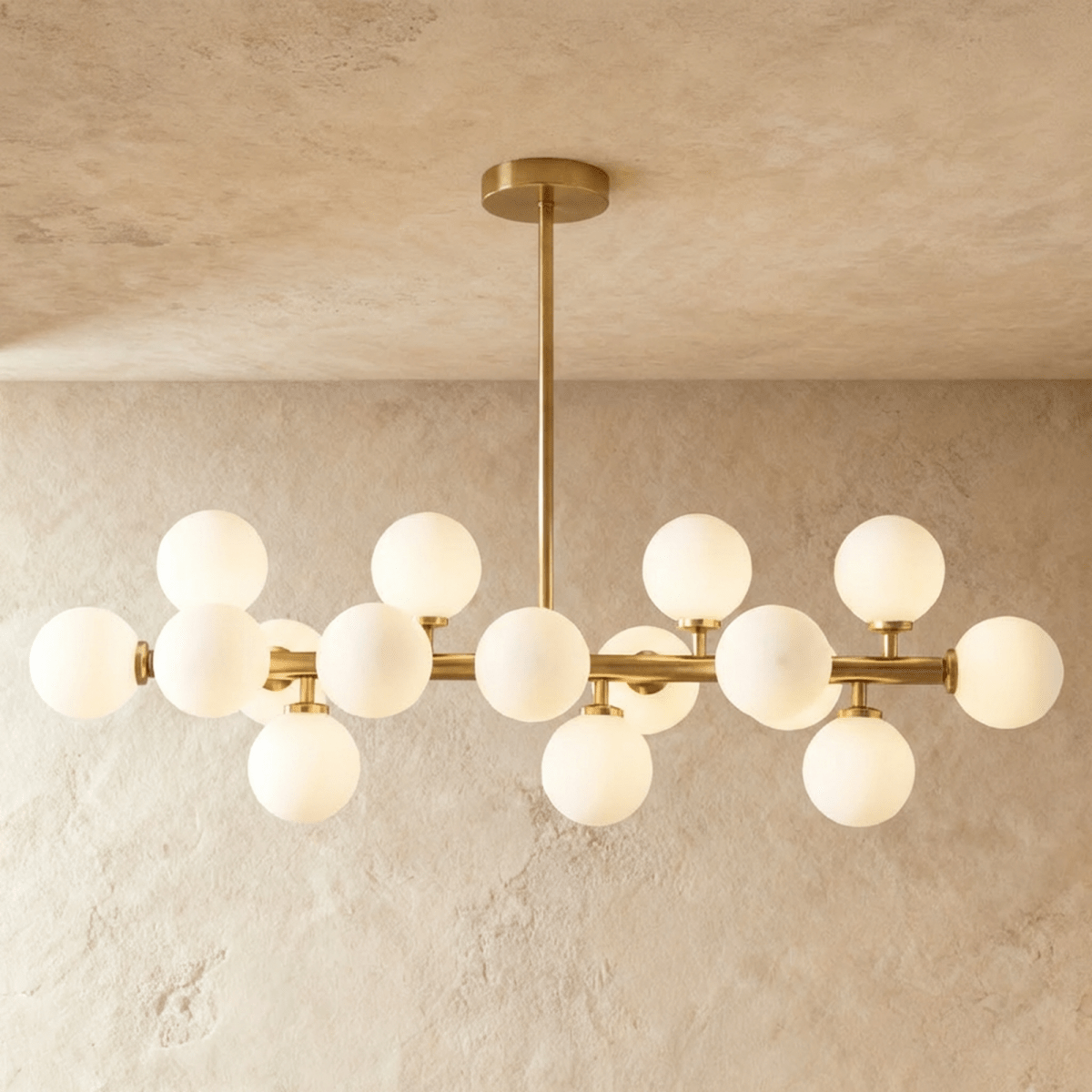 Mid-century modern brass chandelier with 9 spherical frosted glass shades on white background, front view.