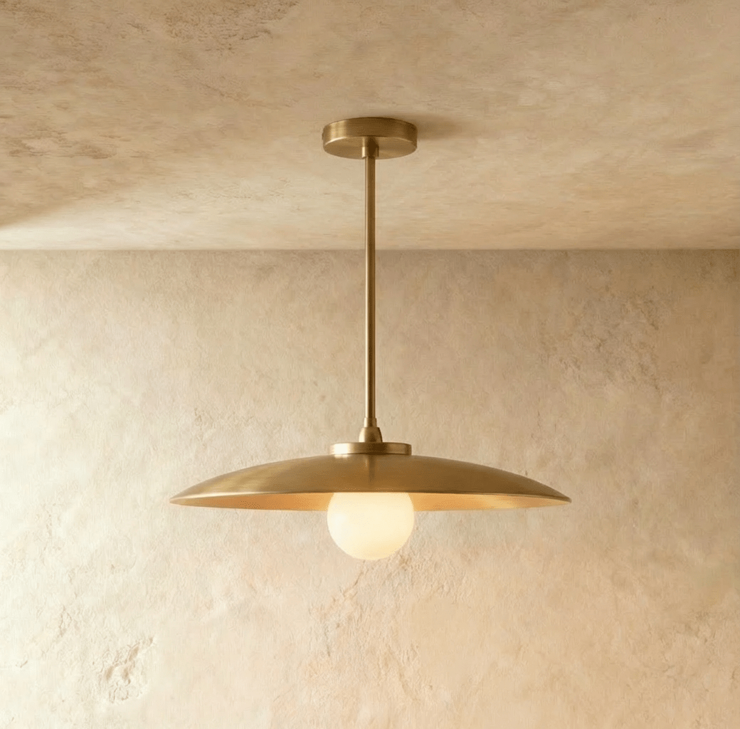 Modern pendant light with wide flat disc shade and exposed bulb, chrome finish, white background, front view.